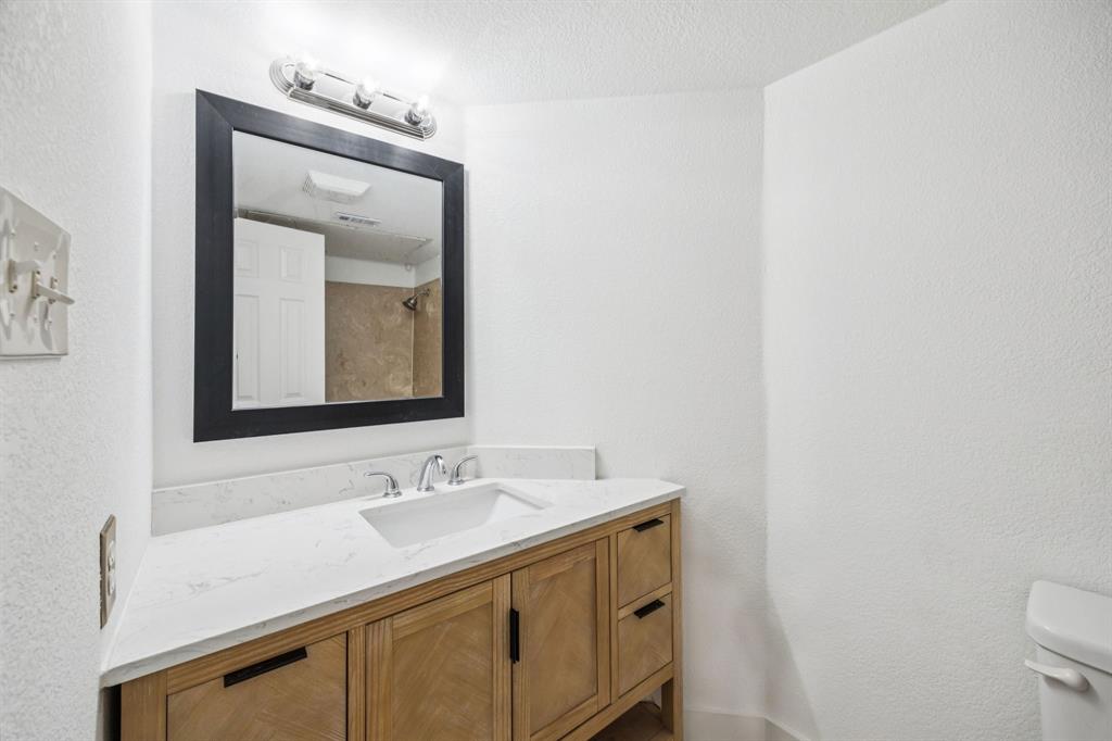 6108 Abrams Road, Unit 410 Dallas, TX 75231 - Photo 7 of 10 a bathroom with a sink vanity and a mirror