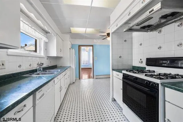 a kitchen with stainless steel appliances granite countertop a stove and a sink
