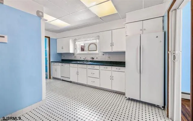 a spacious bathroom with a granite countertop sink a mirror and a shower