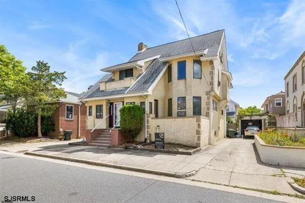 a view of a room with a window and wooden floor