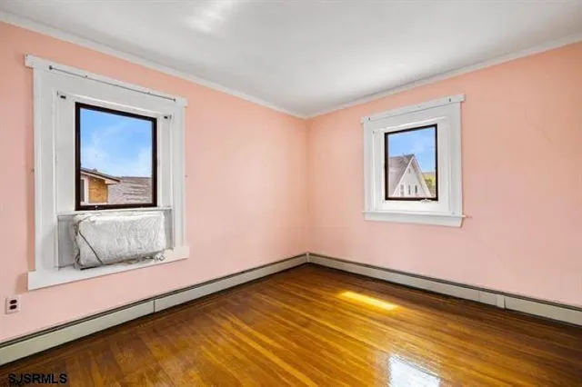 a view of a room with wooden floor and cabinet