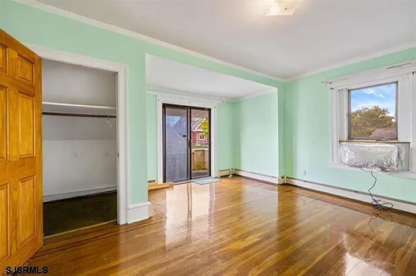 a view of a kitchen with cabinets and wooden floor