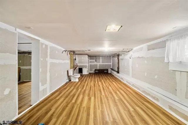 a view of a room with wooden floor