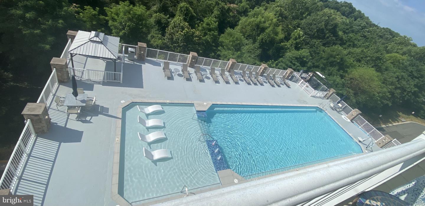 6301 Edsall Road, Unit 123 Alexandria, VA 22312 - Photo 29 of 36 Serene rooftop pool with lush green views.