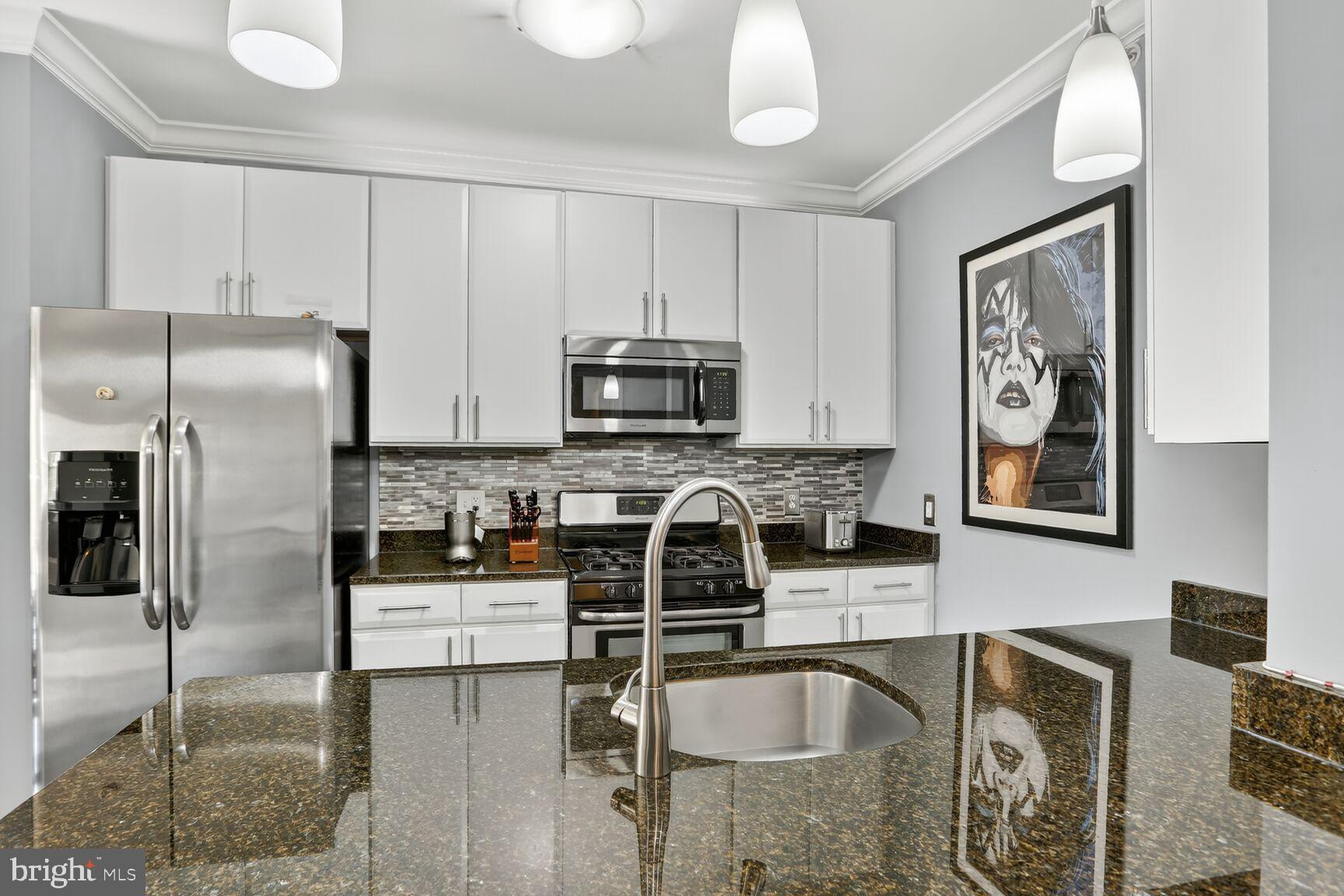 6301 Edsall Road, Unit 123 Alexandria, VA 22312 - Photo 4 of 36 Sleek modern kitchen with elegant finishes.