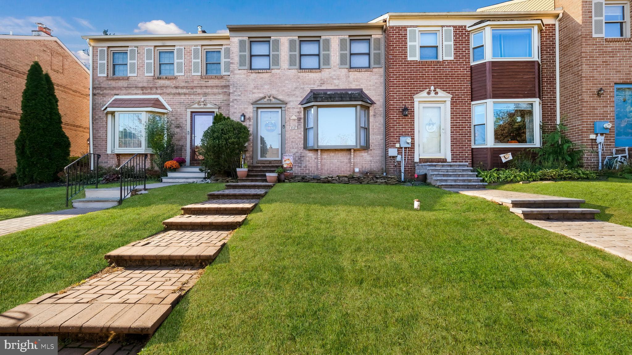 a front view of a house with a yard table and chairs