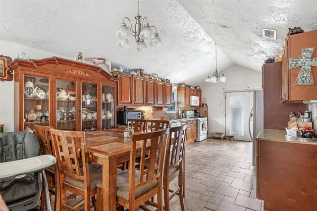 a kitchen with kitchen island granite countertop a sink cabinets and stainless steel appliances