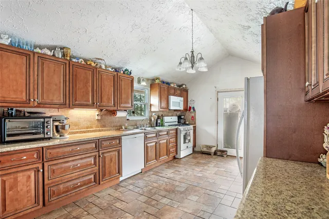 a white refrigerator freezer sitting inside of a kitchen