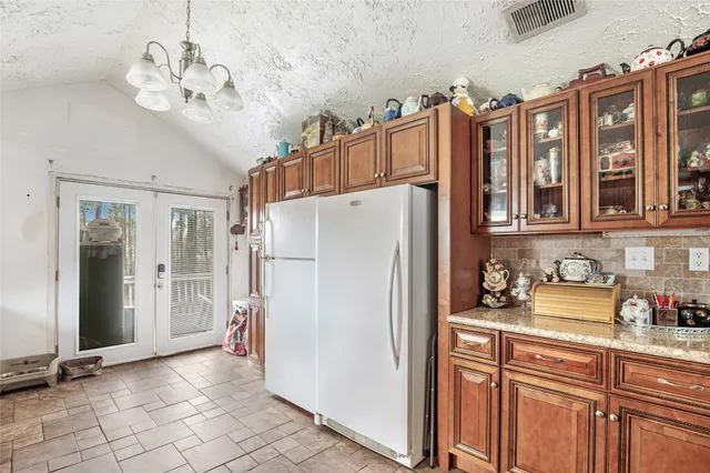 a kitchen with appliances a sink and cabinets