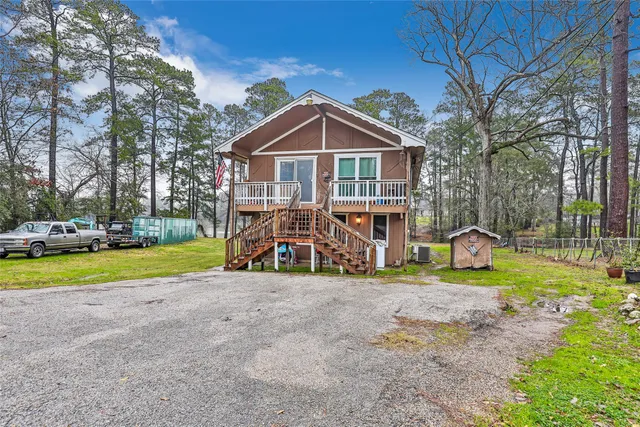 a view of a house with a yard and sitting area