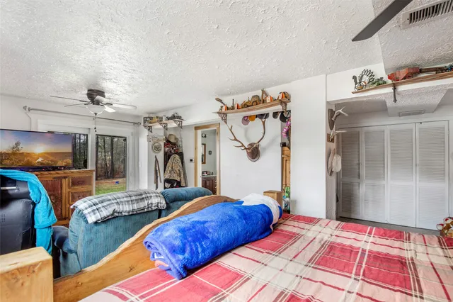 a bedroom with a bed and a chandelier