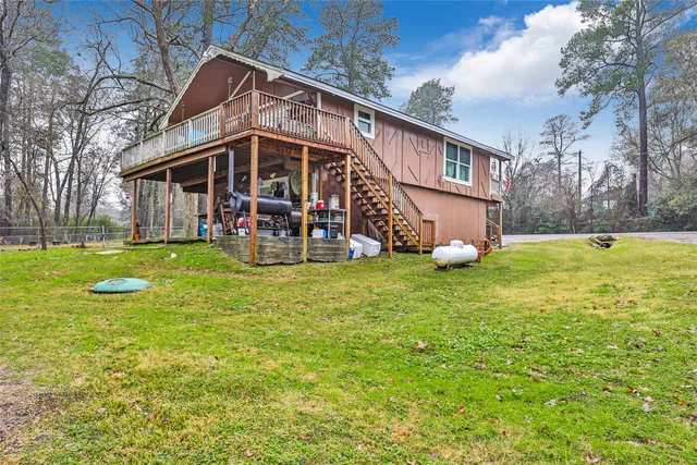a view of a house with a yard and sitting area