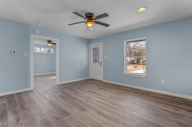 wooden floor in an empty room with a window