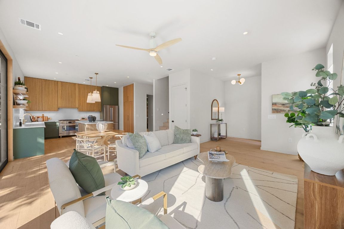 1175 Navasota Street, Unit 2 Austin, TX 78702 - Photo 13 of 40 a living room with furniture dining area and a chandelier