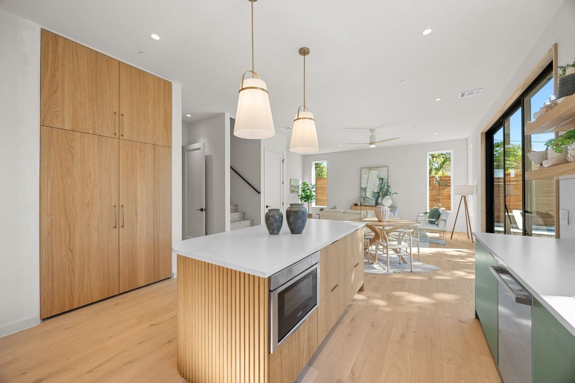 1175 Navasota Street, Unit 2 Austin, TX 78702 - Photo 16 of 40 a very nice looking kitchen with a large counter top space a sink and wooden floor
