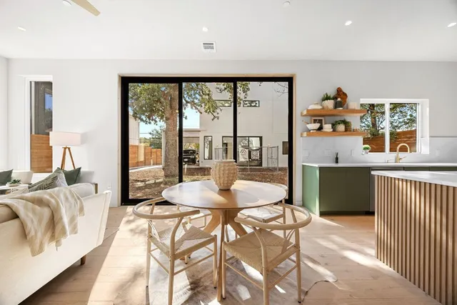 a dining room with furniture and a large window