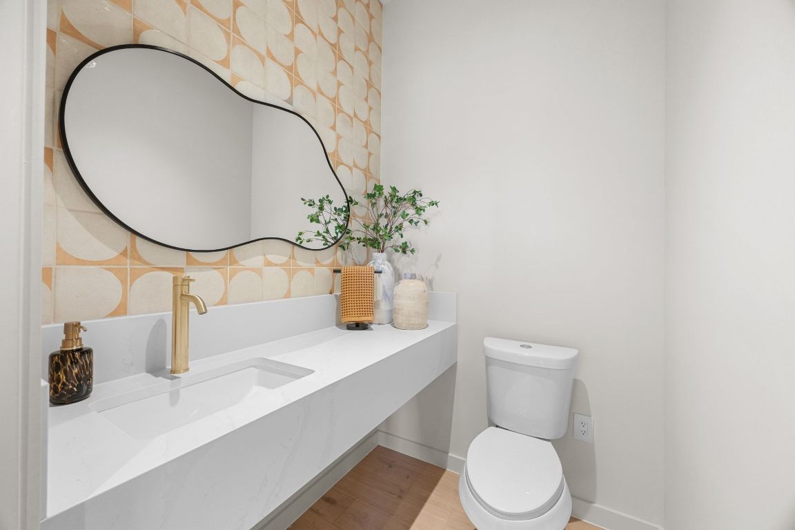 1175 Navasota Street, Unit 2 Austin, TX 78702 - Photo 18 of 40 a bathroom with a toilet sink and mirror