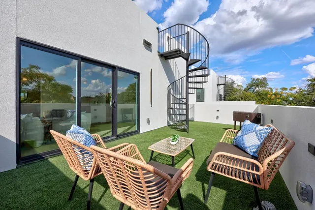 a view of a patio with a table chairs and a backyard