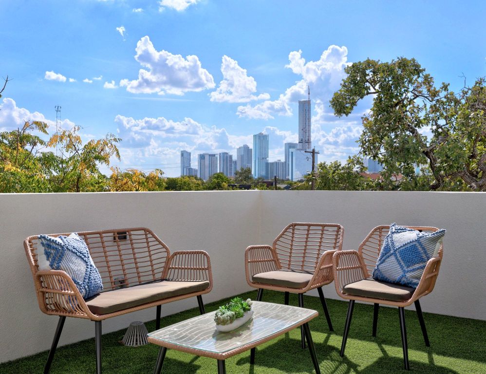 1175 Navasota Street, Unit 2 Austin, TX 78702 - Photo 3 of 40 a view of a chair and table in wooden floor