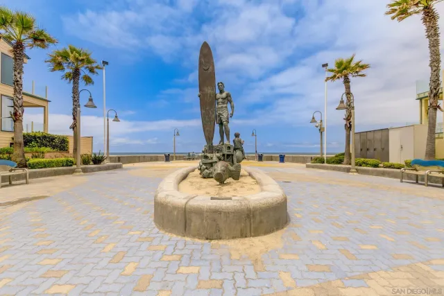 a view of a lobby with a chandelier and potted plants