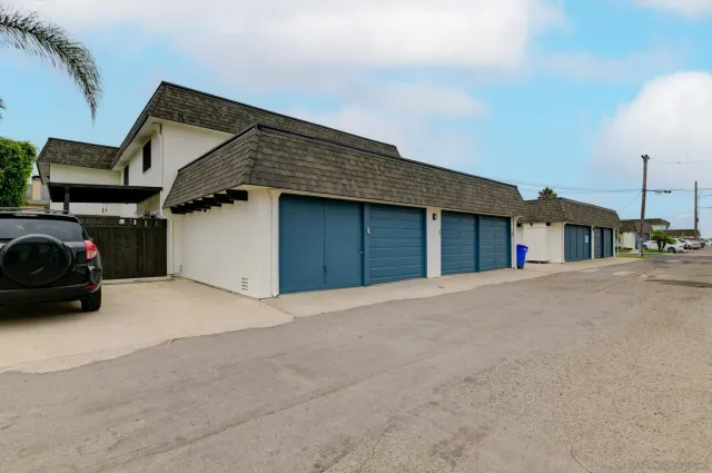 a view of parking house and car parked in front of it