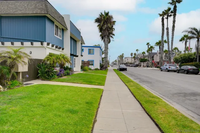 a view of a street with cars parked in front of it