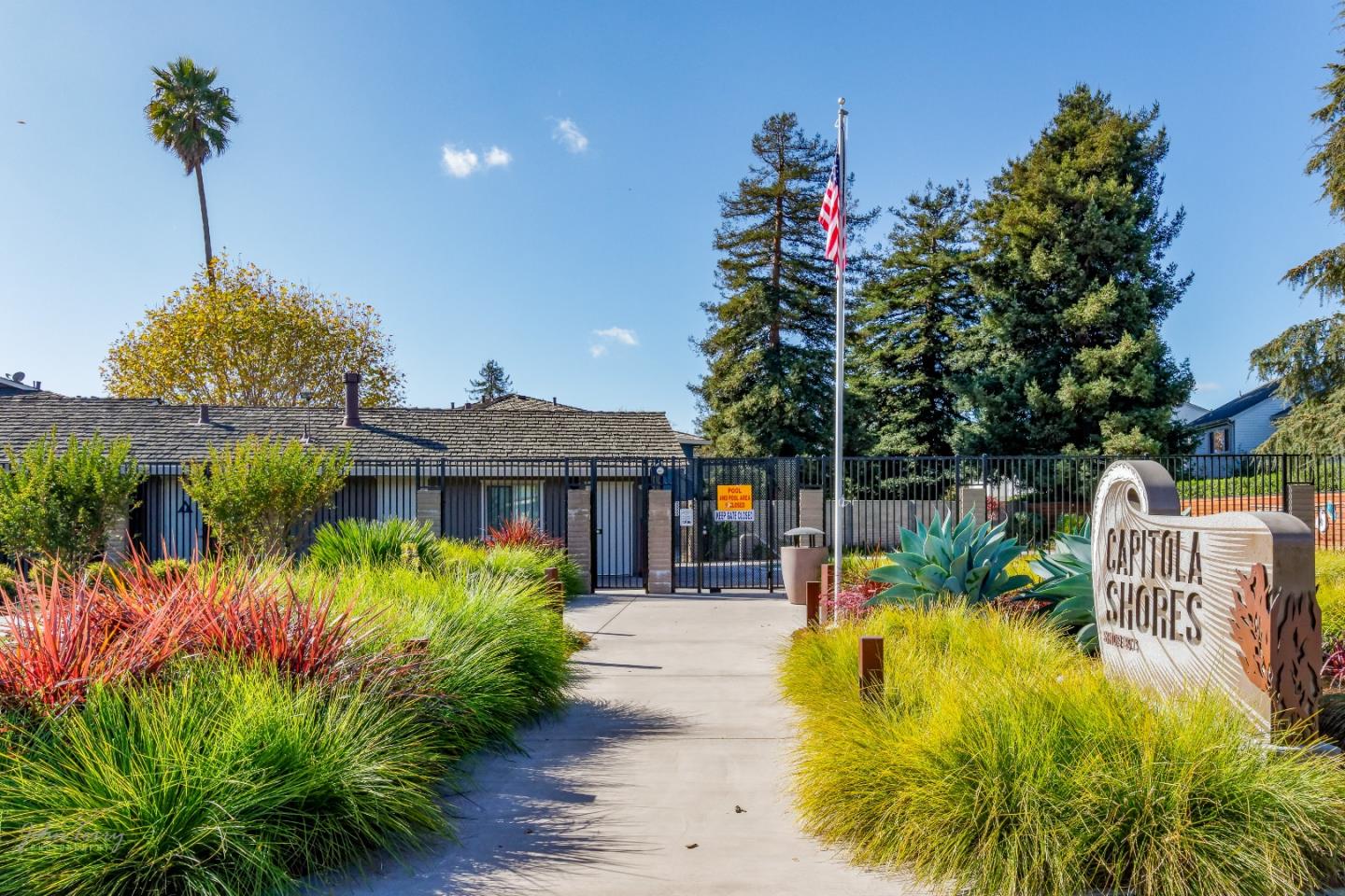 4435 Diamond Street, Unit 1 Capitola, CA 95010 - Photo 14 of 18 a view of a house with large trees and plants