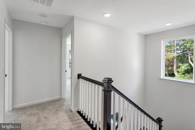a view of a hallway with window and stairs