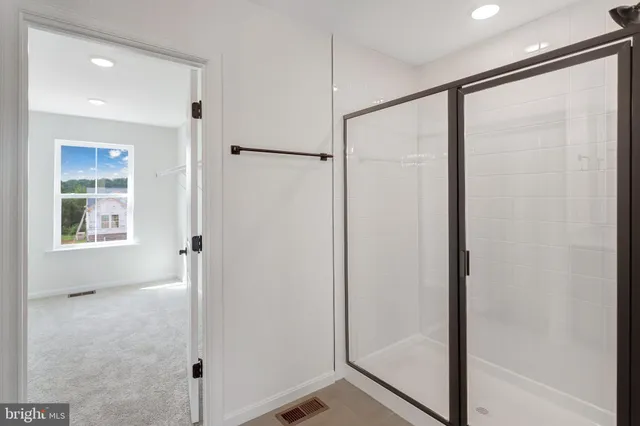 a bathroom with a glass shower door