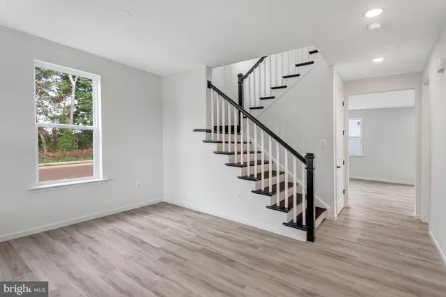a view of room with stairs and wooden floor