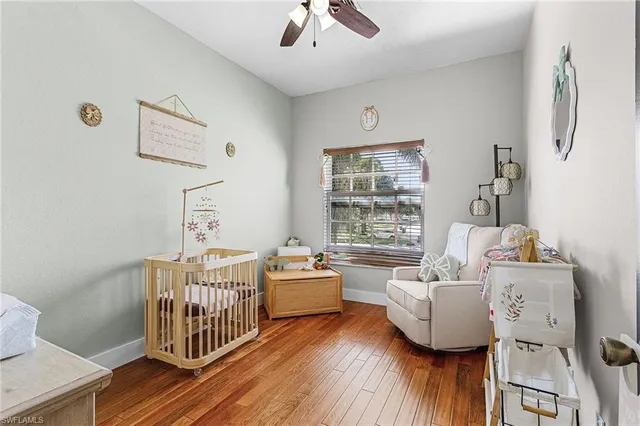 a bedroom with furniture and wooden floor