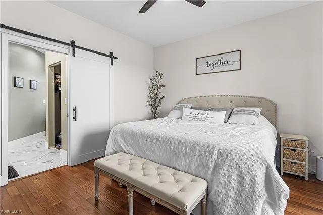 a bedroom with a bed and a night stand