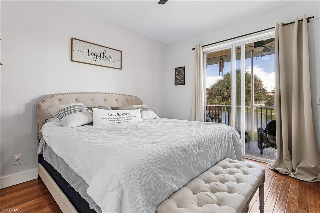 25110 Peacock Lane, Unit 201 Naples, FL 34114 - Photo 14 of 24 a bedroom with a bed and a window