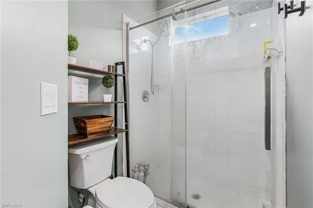 a bathroom with a toilet a sink and shower