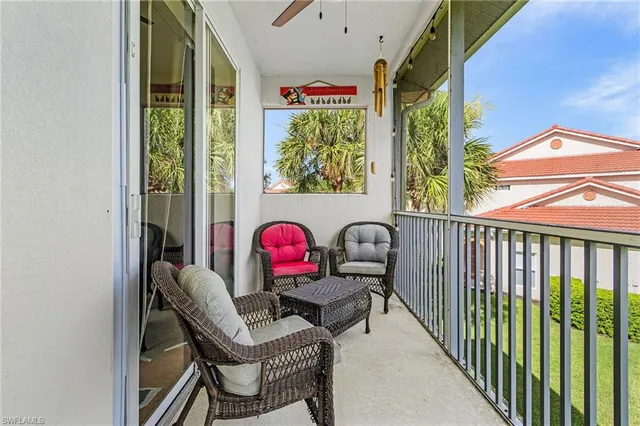 a view of a chairs and table in a balcony