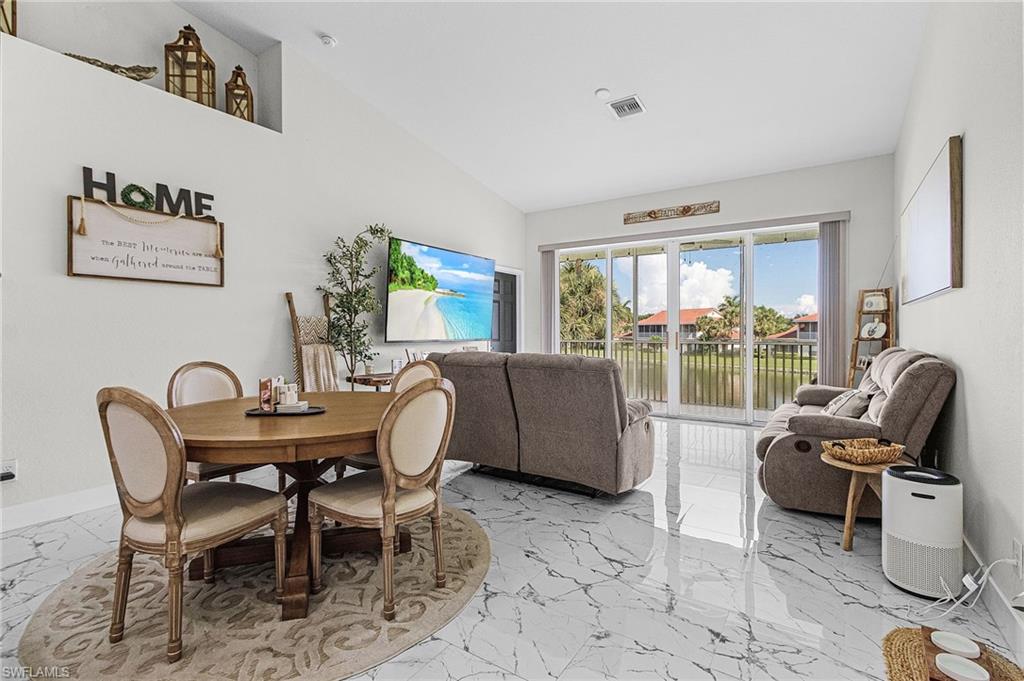 25110 Peacock Lane, Unit 201 Naples, FL 34114 - Photo 2 of 24 a view of a livingroom with furniture and a window