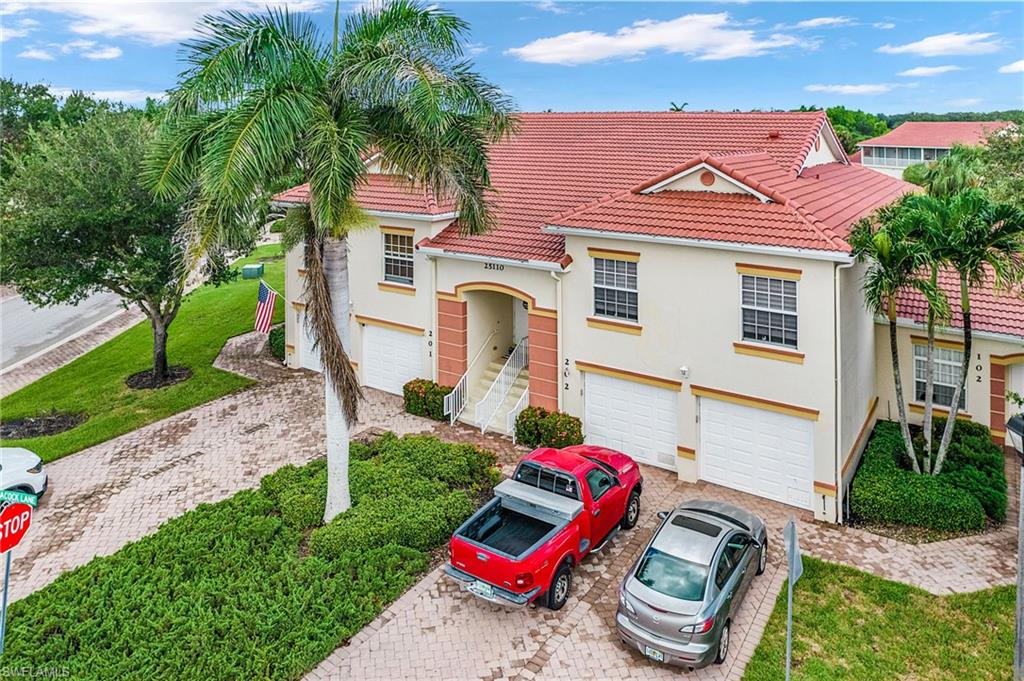 25110 Peacock Lane, Unit 201 Naples, FL 34114 - Photo 21 of 24 a front view of a house with porch