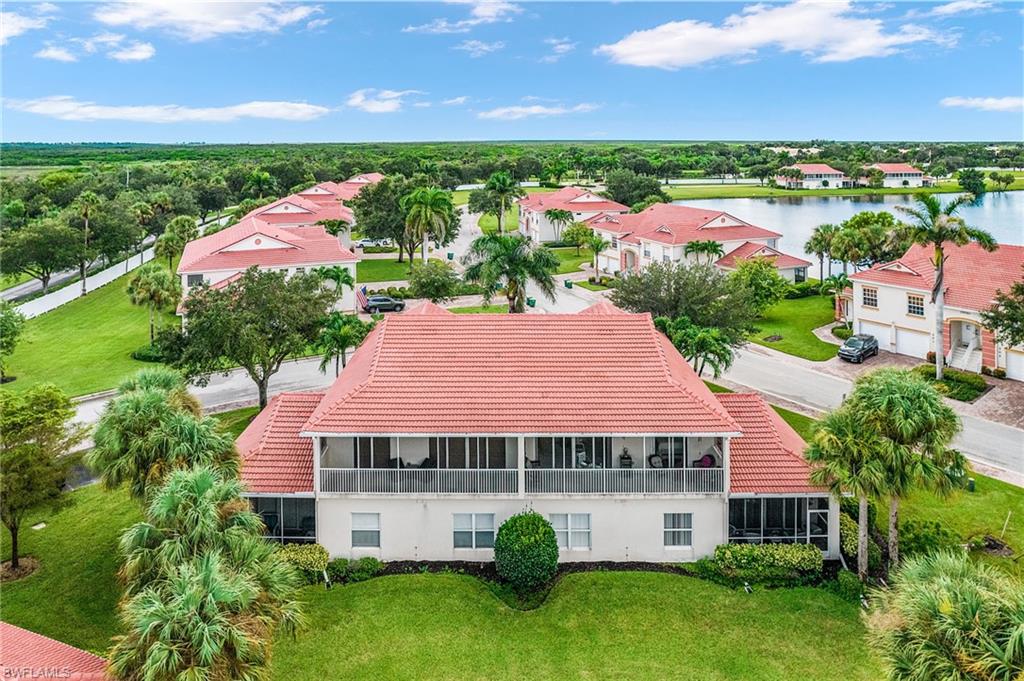 25110 Peacock Lane, Unit 201 Naples, FL 34114 - Photo 22 of 24 a view of a garden with an house in the background