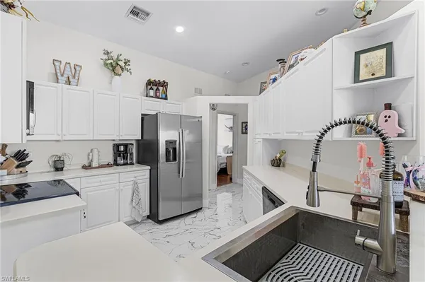 a kitchen with a refrigerator and cabinets