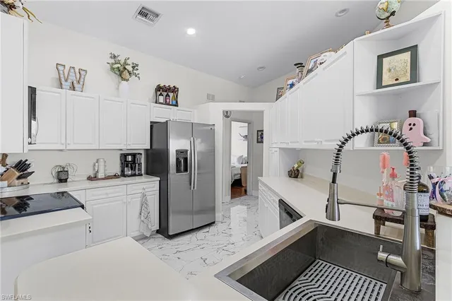 a kitchen with a refrigerator and cabinets