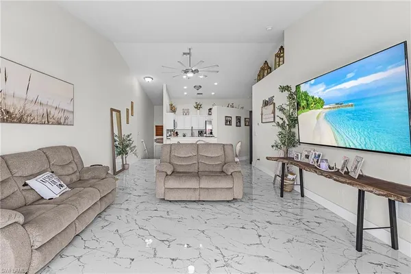 a living room with furniture a rug and a flat screen tv