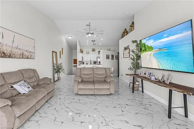 a living room with furniture a rug and a flat screen tv