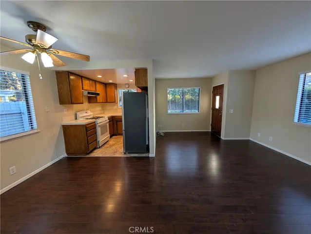 a view of a kitchen with microwave and wooden floor