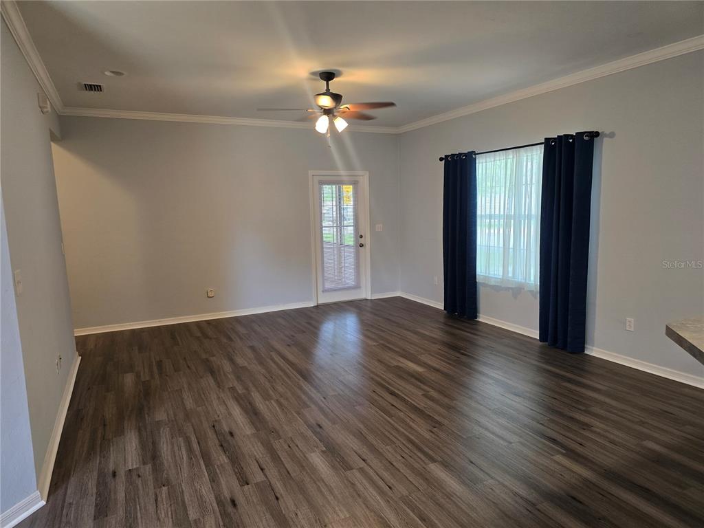 7976 48 Way Gainesville, FL 32653 - Photo 4 of 26 a view of an empty room with wooden floor and a window