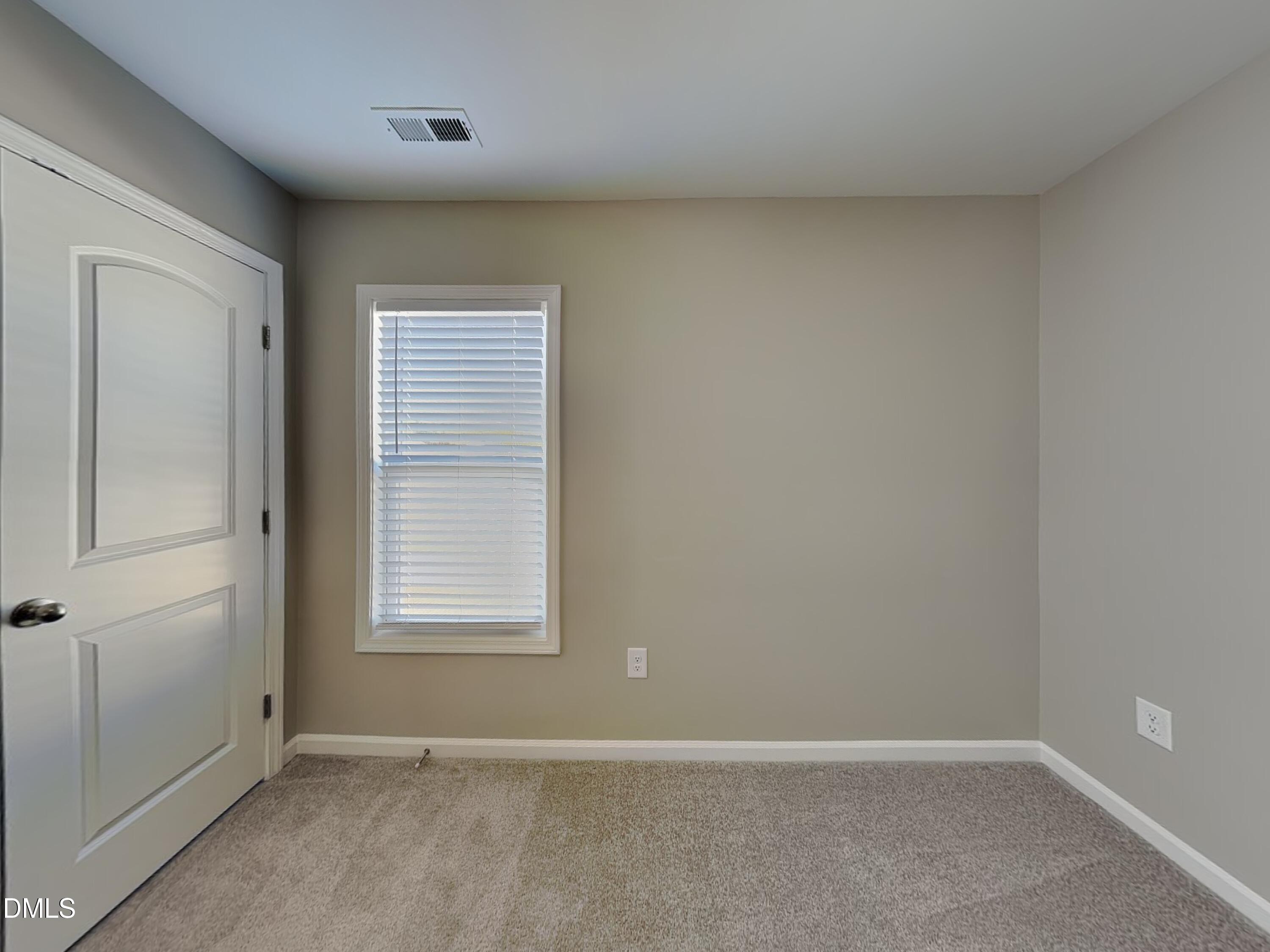 376 Olde Place Zebulon, NC 27597 - Photo 12 of 15 an empty room with windows