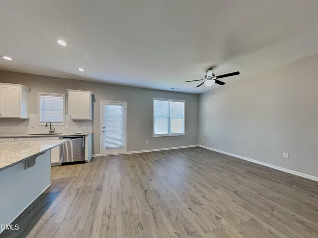 a view of kitchen with a sink wooden floor and a kitchen