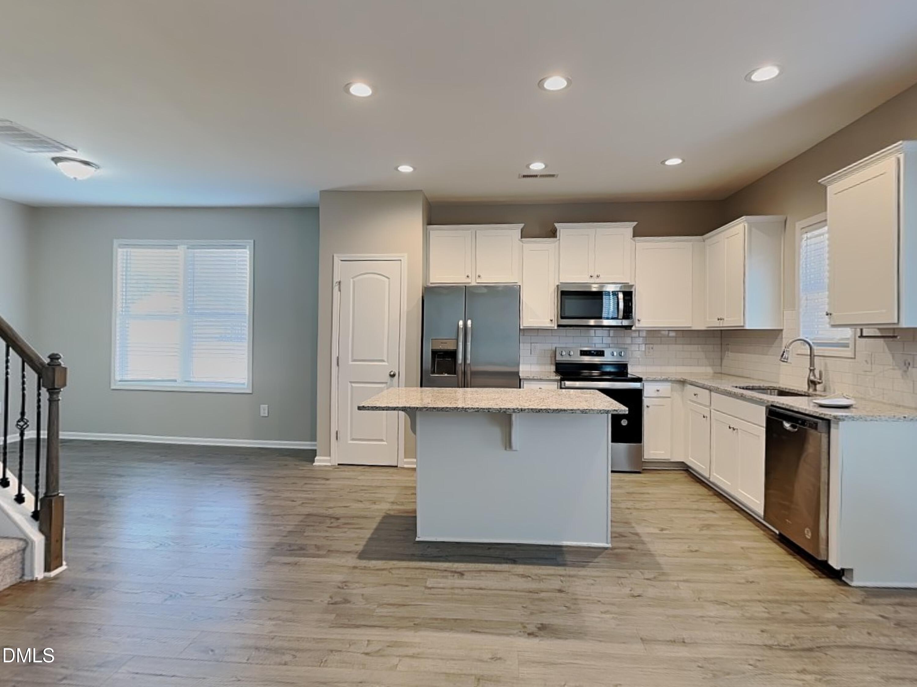 376 Olde Place Zebulon, NC 27597 - Photo 6 of 15 a kitchen with a refrigerator and a stove top oven
