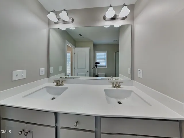 a bathroom with a sink a mirror and vanity
