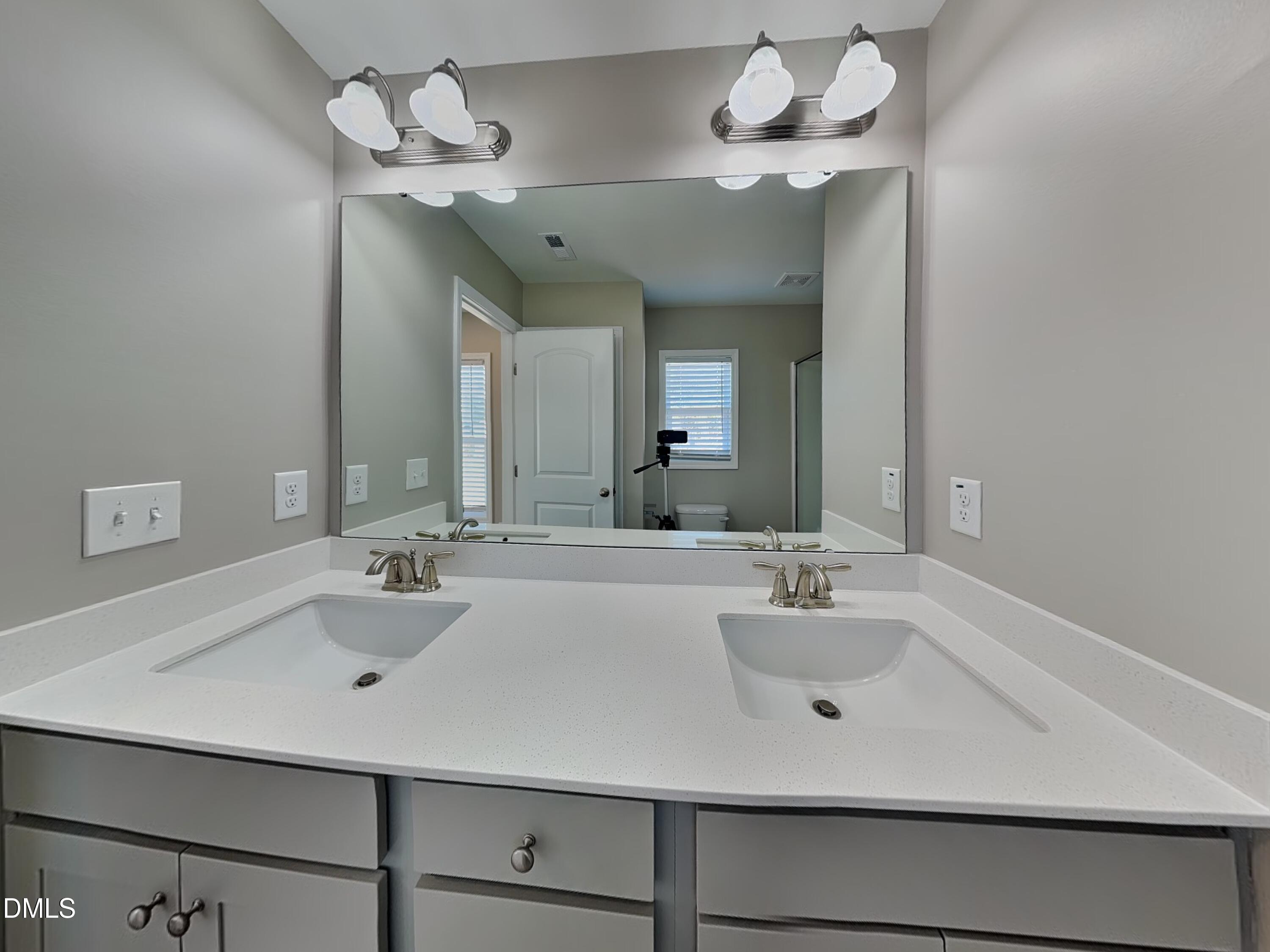 376 Olde Place Zebulon, NC 27597 - Photo 9 of 15 a bathroom with a sink a mirror and vanity