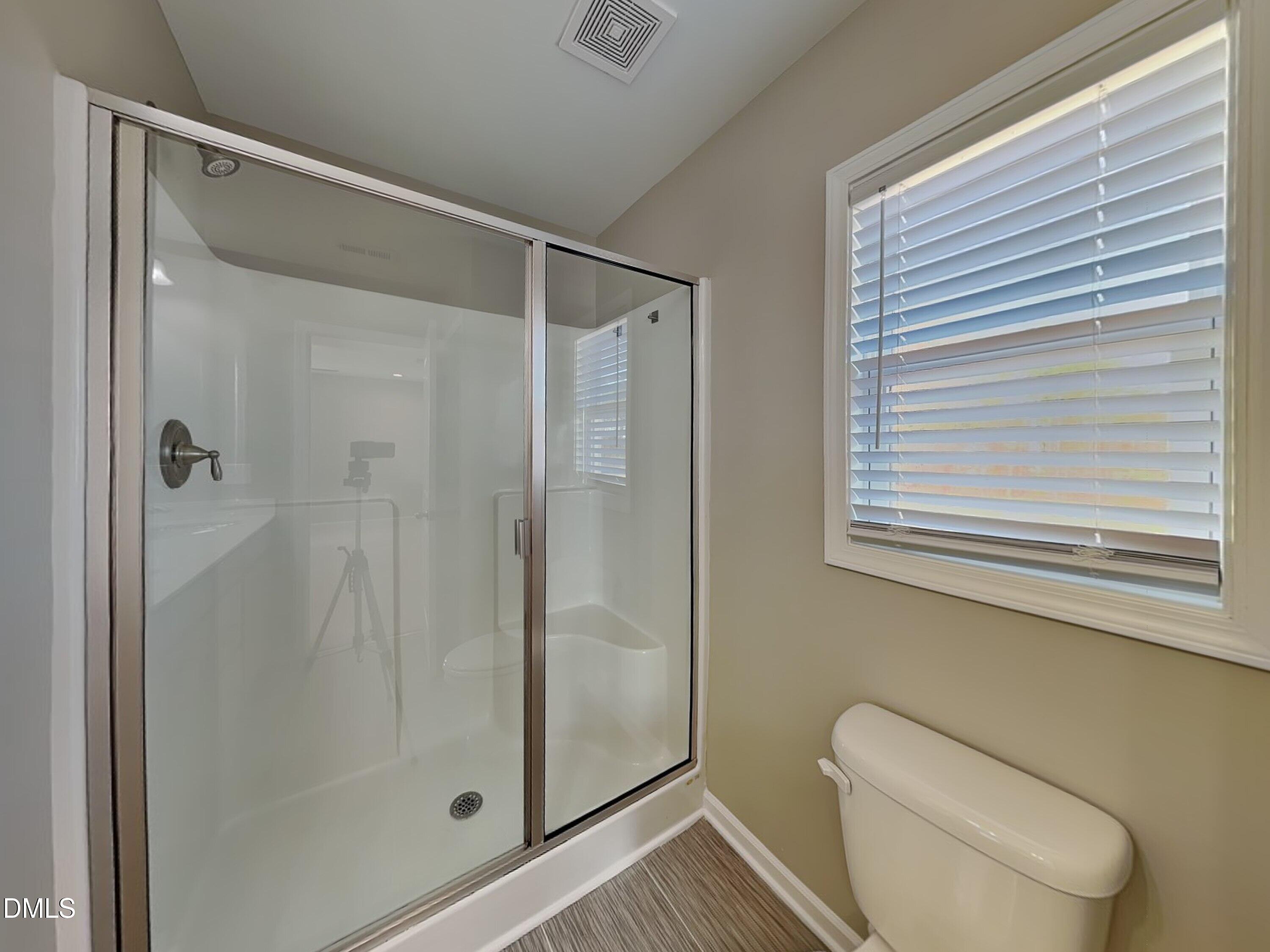 376 Olde Place Zebulon, NC 27597 - Photo 10 of 15 a bathroom with a shower and toilet